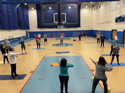 A group fitness class stretching together in the gym